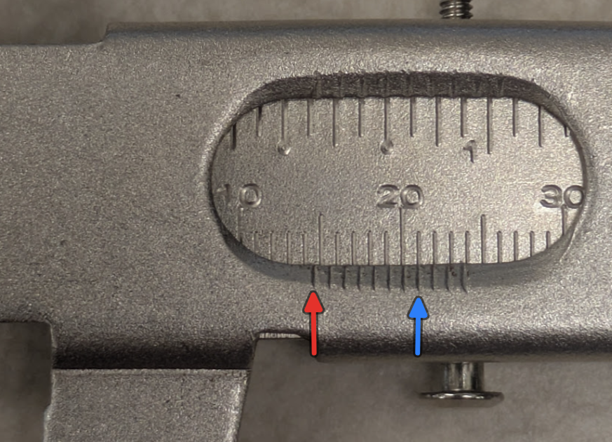 Example - The red line zero lines up after 14mm on the main scale it is 4 ticks after the ”10”. The blue line is the only line on the vernier scale that lines up with any line on the main scale, and it is the 8th tick, meaning it is 0.7mm. The final measurement would be 14.7mm.