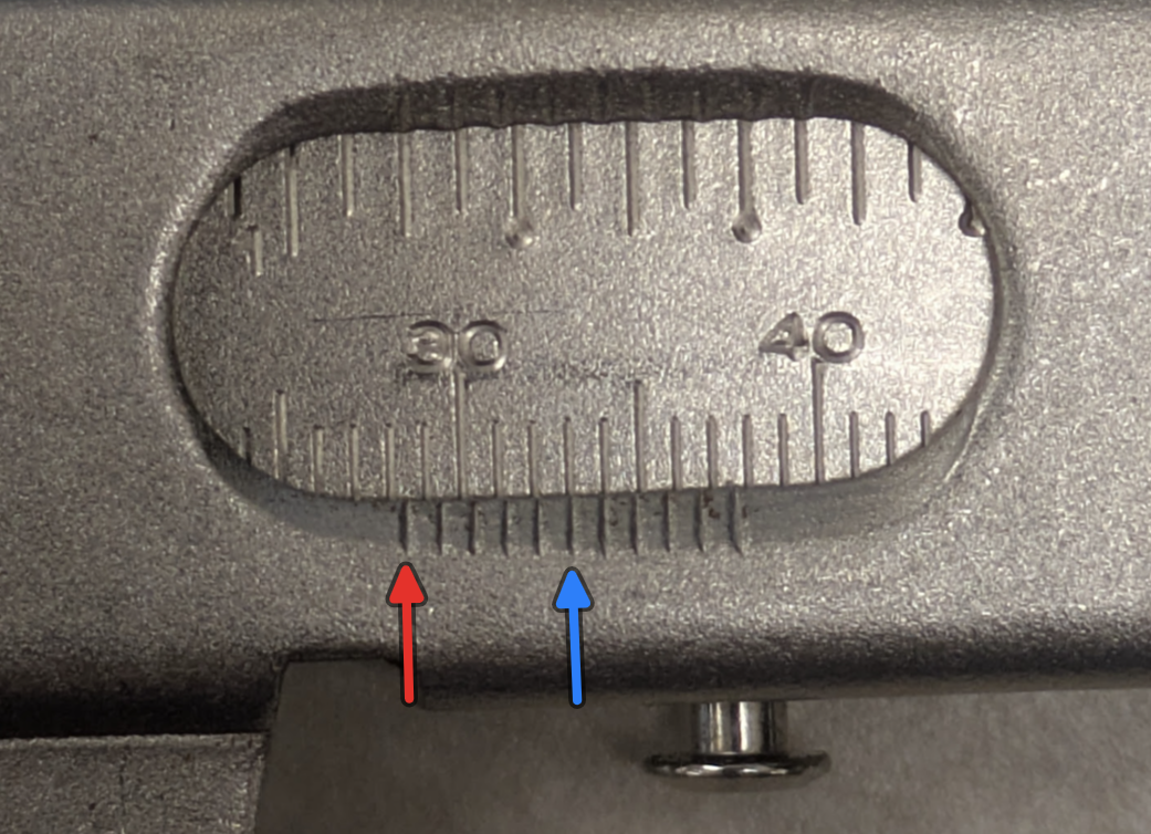 Example - This measurement reads 28.5mm since the red arrow zero on the vernier is just after the 28th tick on the main scale, and the blue arrow 6th tick on the vernier scale lines up with one of the lines on the main scale.