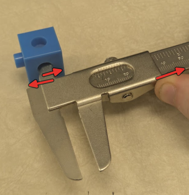 For circular measurements, rotate the jaws inside of the part to ensure you are getting the full diameter. The jaws should make square contact on the interior of the part. Light tension should be applied to the right using the thumb screw.